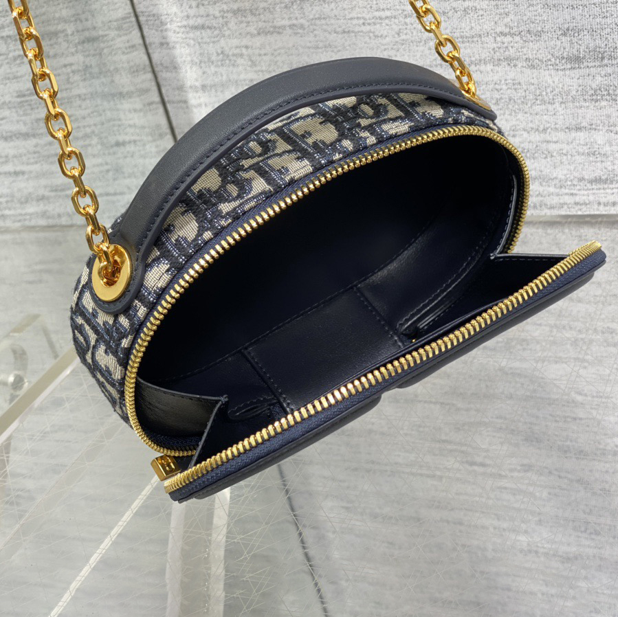 Doir Elliptical Camera Bag Features A Unique Letter Embossed Logo And Spacious Compartment Design. It Is Equipped With A Leather Top Handle And An Adjustable And Detachable Chain Shoulder Strap That Can Be Carried By Hand. The Shoulder Back Or Crossb