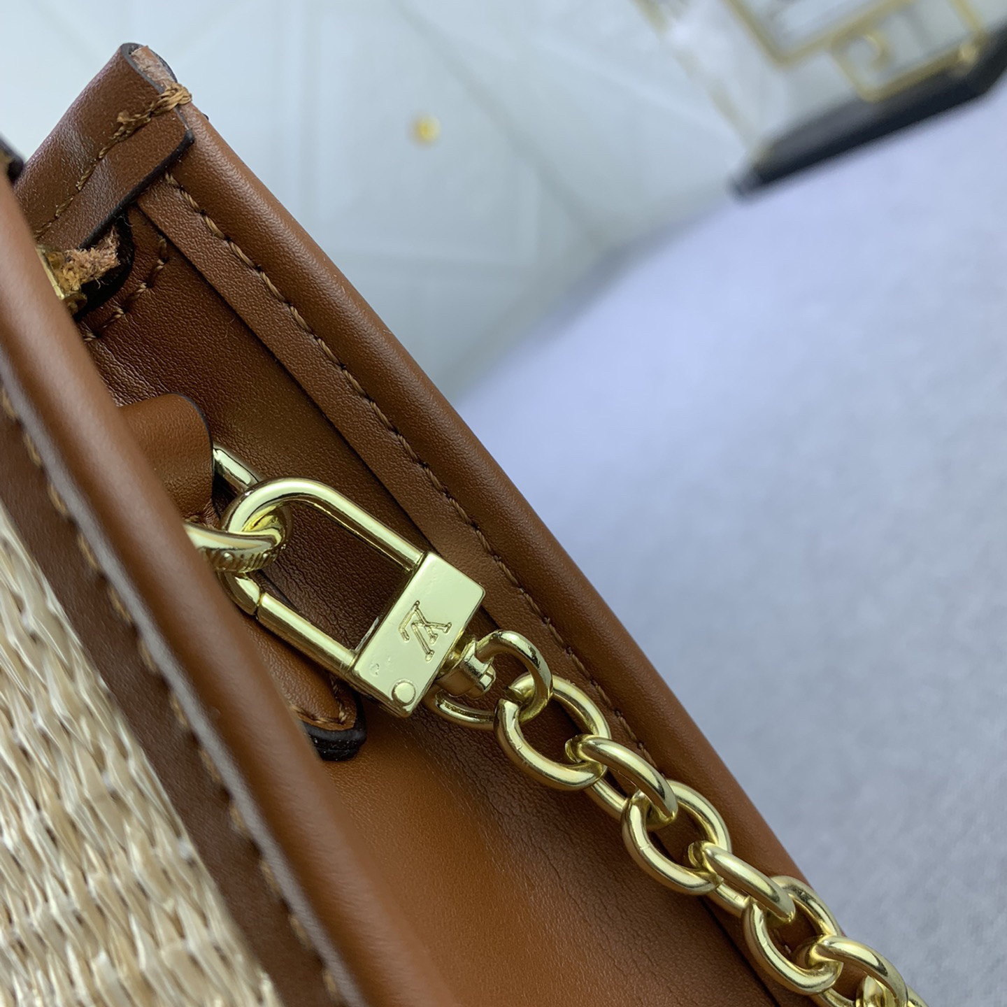 The LV High Quality Women Shoulder Bags Luxury Caramel Chain Toiletry Bag is made of natural Lafite Grass and features black leather and the Circle logo on the side Ladies Clutch Bag Shoulder Tote Female Purse Wallet Hand Bag