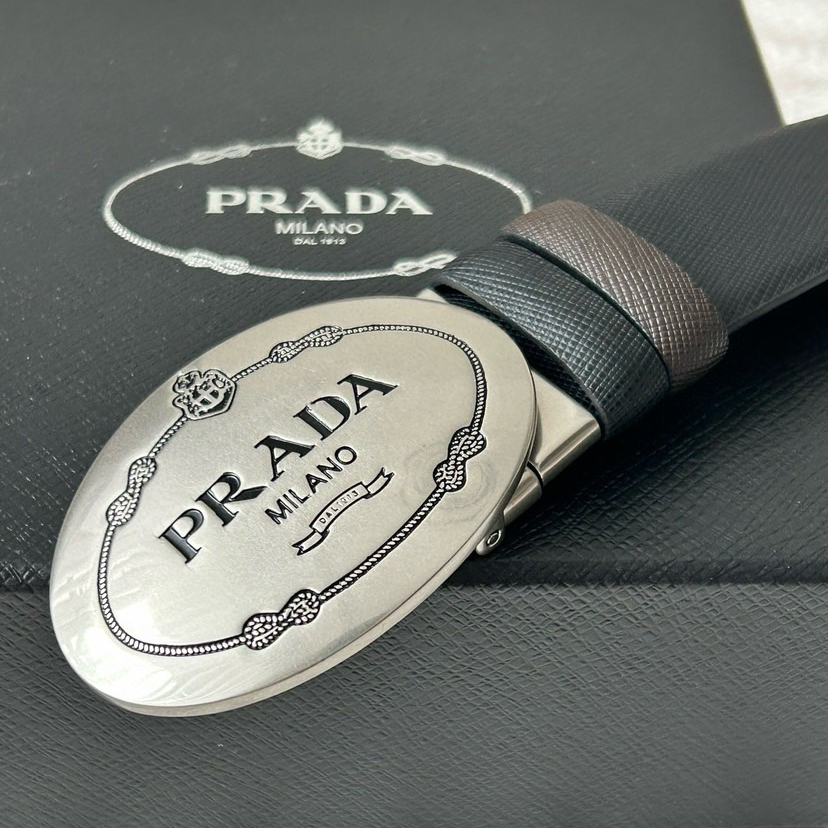 Prada Men's Business And Leisure Double Sided Belt Width 3.4cm Made Of Double Sided Saffiano Black With Coffee Head Leather Prada Logo Engraved In Elliptical Polished Steel Metal Buckle Contrasting Color Belt Loop Exquisite And Elegant